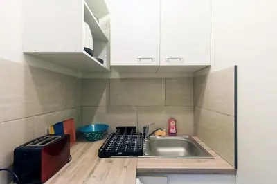 a small kitchen with a sink and a microwave at MIPIM Dispo Perle Rare Croisette A côté de l Hôtel Carlton Centre Croisette 5mn du Palais 4P Plage 1Mn in Cannes