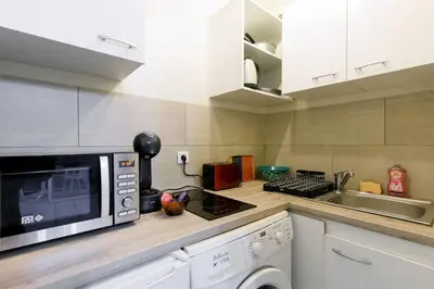 a kitchen with a microwave and a sink at MIPIM Dispo Perle Rare Croisette A côté de l Hôtel Carlton Centre Croisette 5mn du Palais 4P Plage 1Mn in Cannes