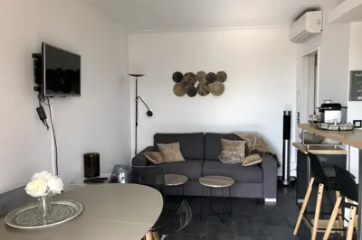 a living room with a couch and a table at Cosy 42m With Balcony Nice View And Wifi in Cannes