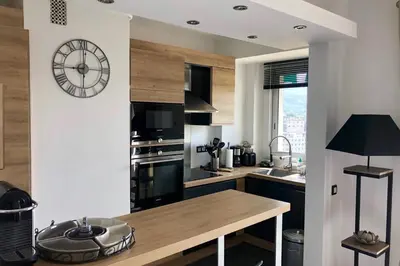 a kitchen with a large clock on the wall at Cosy 42m With Balcony Nice View And Wifi in Cannes