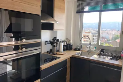 a kitchen with a sink and a stove top oven at Cosy 42m With Balcony Nice View And Wifi in Cannes