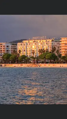 a large building on the shore of a body of water at 2 pièces cannes centre in Cannes