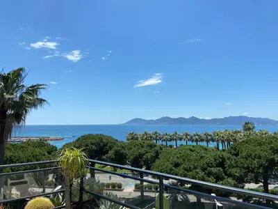 a view of the ocean from the balcony of a resort at palm Beach studio vue port Canto in Cannes