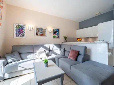 a living room with a couch and a table at Apartment Villa Francia-2 by Interhome in Cannes