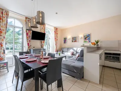 a kitchen and living room with a table and a couch at Apartment Villa Francia-2 by Interhome in Cannes