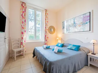 a bedroom with a bed and a tv and a window at Apartment Villa Francia-1 by Interhome in Cannes