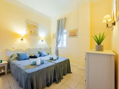 a bedroom with a bed with blue pillows at Apartment Villa Francia-1 by Interhome in Cannes