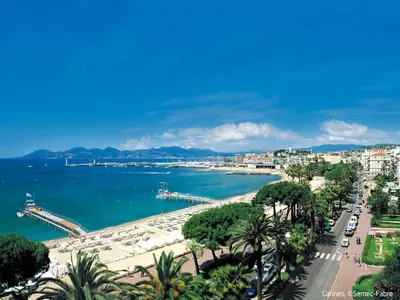 a view of a city and the ocean with palm trees at Apartment Villa Francia-1 by Interhome in Cannes