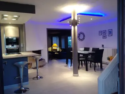 a kitchen and dining room with a cross on the floor at Villa élégante avec piscine privée à Le Cannet in Le Cannet