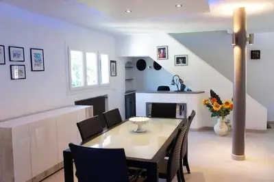 a kitchen and dining room with a table and chairs at Villa élégante avec piscine privée à Le Cannet in Le Cannet