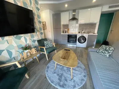 a living room with a couch and a table at CHEZ MATHIEU in Cannes