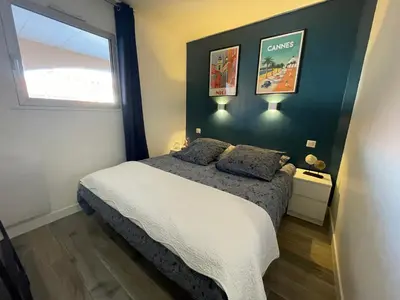 a bedroom with a bed with two pillows on it at CHEZ MATHIEU in Cannes