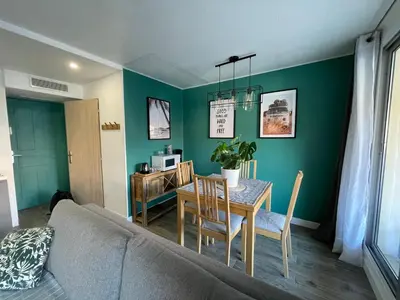 a living room with a table and a dining room at CHEZ MATHIEU in Cannes