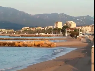 a view of a beach with buildings in the background at CHEZ MATHIEU in Cannes