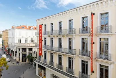 a building with orange signs on the side of it at 3 Bed - Ascenseur - 2 min du Palais - Climatisé in Cannes