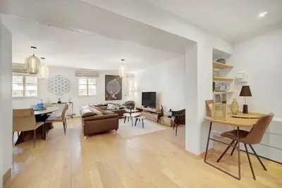 a living room with a couch and a dining room at Cannes banane 50m croisette, luxueux 4 pièces dans résidence de standing in Cannes