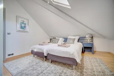 a bedroom with a large bed in a attic at Cannes banane 50m croisette, luxueux 4 pièces dans résidence de standing in Cannes