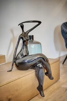 a metal statue of a woman sitting on a table at Cannes banane 50m croisette, luxueux 4 pièces dans résidence de standing in Cannes