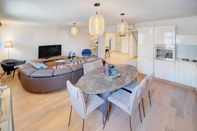 a living room with a table and a couch at Cannes banane 50m croisette, luxueux 4 pièces dans résidence de standing in Cannes