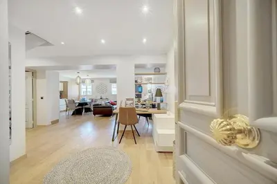 a living room and a kitchen with a dining room and a living room at Cannes banane 50m croisette, luxueux 4 pièces dans résidence de standing in Cannes