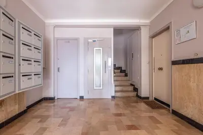 a hallway with white walls and a staircase in a building at Appart 1 pièce pointe de la Croisette à cannes in Cannes