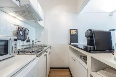 a kitchen with a sink and a microwave at Appart 1 pièce pointe de la Croisette à cannes in Cannes