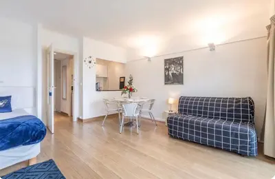 a bedroom with a bed and a table and a couch at Appart 1 pièce pointe de la Croisette à cannes in Cannes