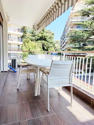 a white table and chairs on a balcony at One bedroom flat with terrace, 250m from the beach and La Croisette, Behind the Martinez Hotel in Cannes