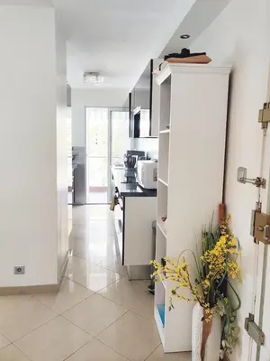 a living room with a television on a tiled floor at One bedroom flat with terrace, 250m from the beach and La Croisette, Behind the Martinez Hotel in Cannes