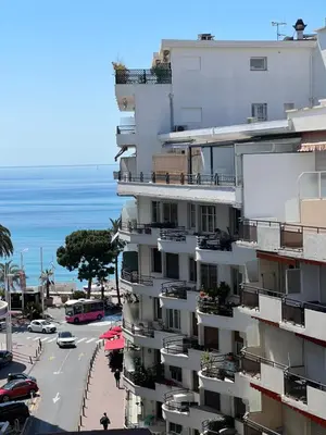 a tall building with a view of the ocean at Cosy 2 bedrooms apartment Croisette in Cannes