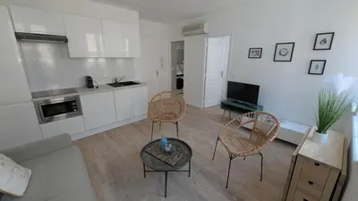 a living room with two chairs and a table at La Fontaine in Cannes