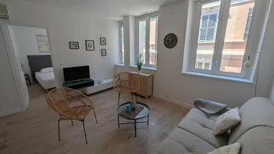 a living room with a couch and two chairs at La Fontaine in Cannes