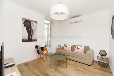 a living room with a couch and a table at August in Cannes