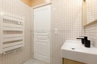 a bathroom with a sink and a white door at August in Cannes