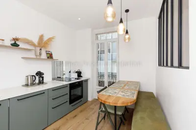 a kitchen with a table in the middle of it at August in Cannes