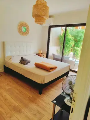 a bedroom with a bed and a large window at Garden Flat in Cannes in Cannes