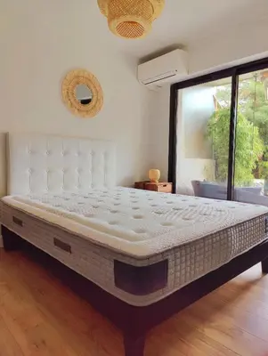 a large bed in a room with a large window at Garden Flat in Cannes in Cannes