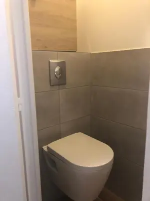 a bathroom with a white toilet in a room at ORION in Cannes