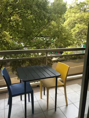 a black table and two chairs on a balcony at ORION in Cannes