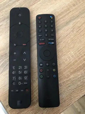 two remote controls sitting on top of a table at ORION in Cannes