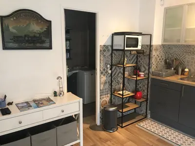 a kitchen with a counter and a microwave on a shelf at ORION in Cannes