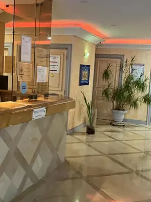 a lobby with two potted plants and a counter at Appartamento in riva al mare a Cannes in Cannes