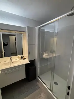 a bathroom with a glass shower and a sink at Appartamento in riva al mare a Cannes in Cannes
