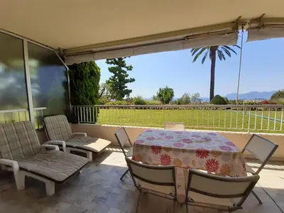 a living room with a couch and a table at Le Renoir in Cannes