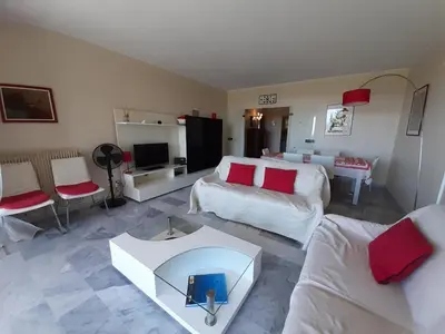 a bedroom with a large bed and a large window at Le Renoir in Cannes