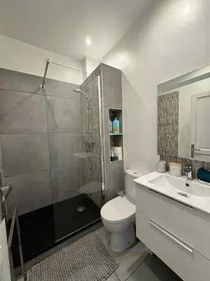 a room with two beds and a large window at Maison de ville à Cannes à 450 mètres de la Croisette in Cannes