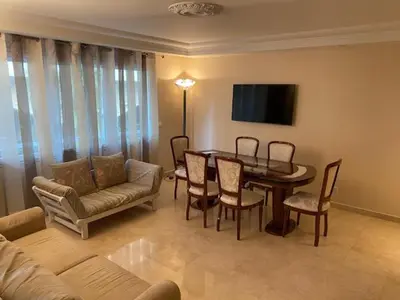 a living room with a table and chairs and a couch at Chez Babette in Cannes