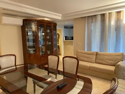a living room with a glass table and a couch at Chez Babette in Cannes