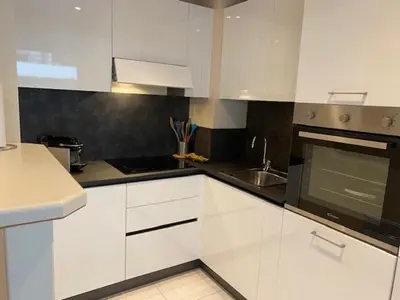 a kitchen with white cabinets and a stove top oven at Chez Babette in Cannes