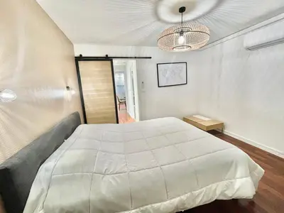 a bedroom with a large white bed in it at Carré d'or Duplex, by Welcome to Cannes in Cannes